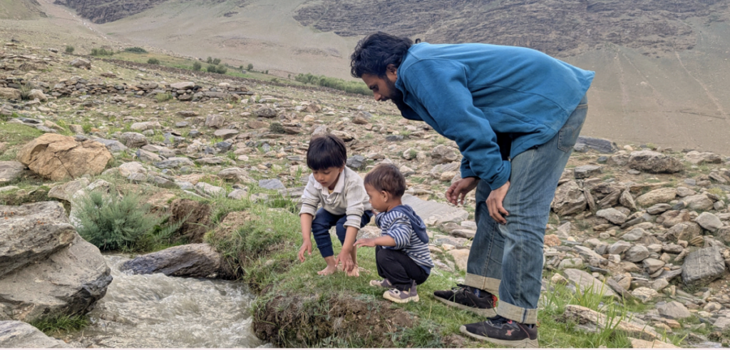 A father and two kids in the mountains - family travel
